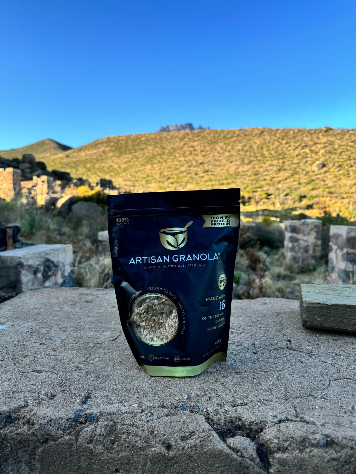 Artisan Granola at Mount Kilimanjaro – climber enjoying healthy, energy-packed granola snack at sunrise during high-altitude trek to Uhuru Peak.