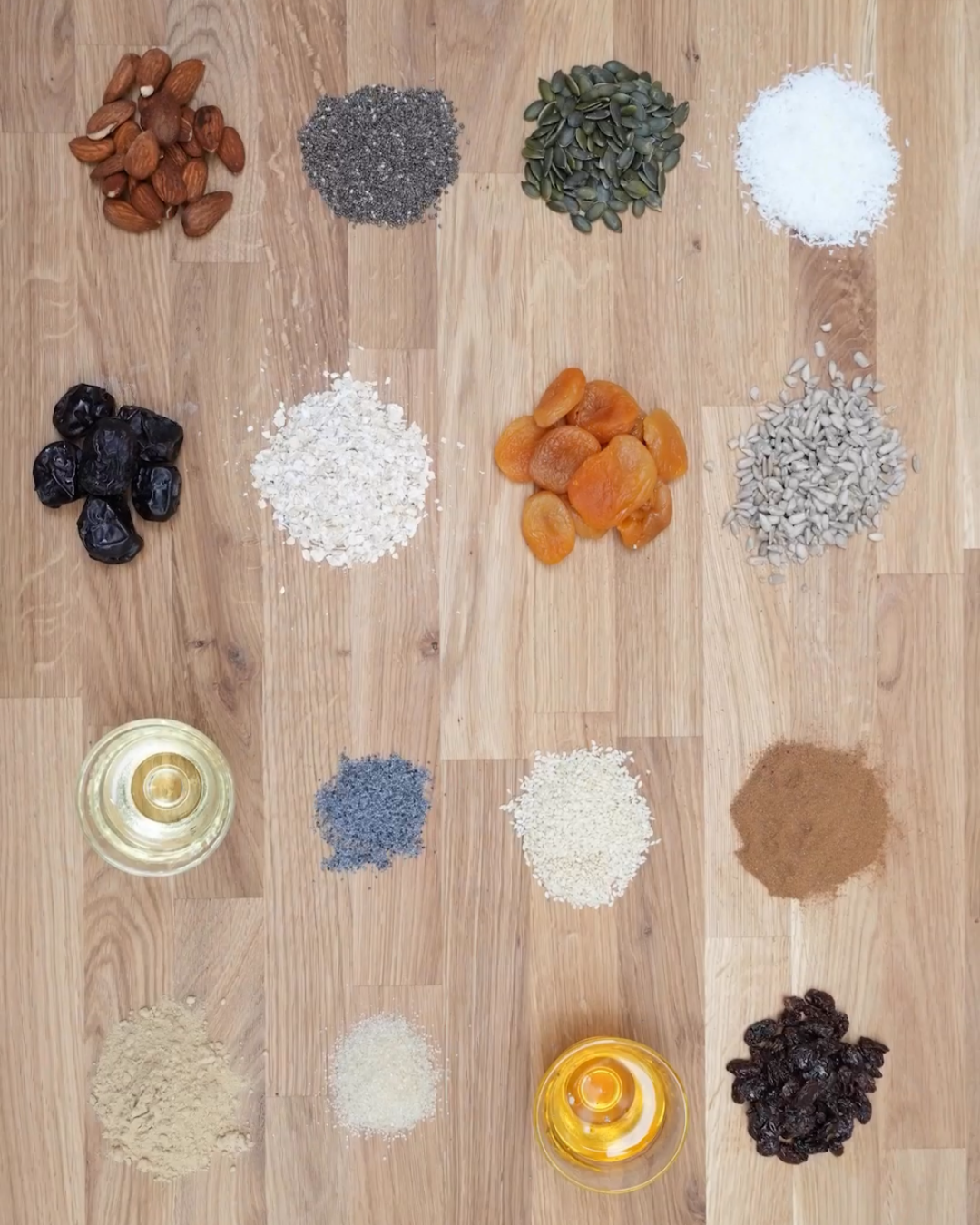 Flat lay of Artisan Granola ingredients – oats, nuts, seeds, dried fruit, honey and spices – showing 60% fruit, nuts and seeds and only 40% oats for a nutrient-rich breakfast blend.