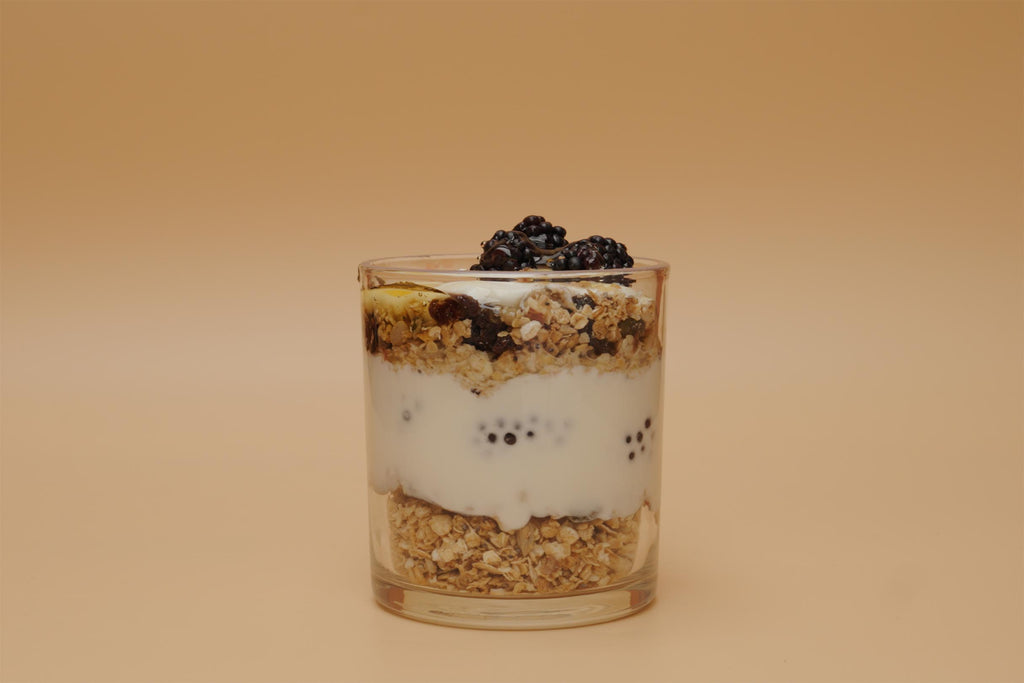 Artisan Granola parfait layered with creamy yoghurt, blackberries and natural oats in a glass — a wholesome, high-fibre, handmade breakfast rich in flavour and nutrition.
