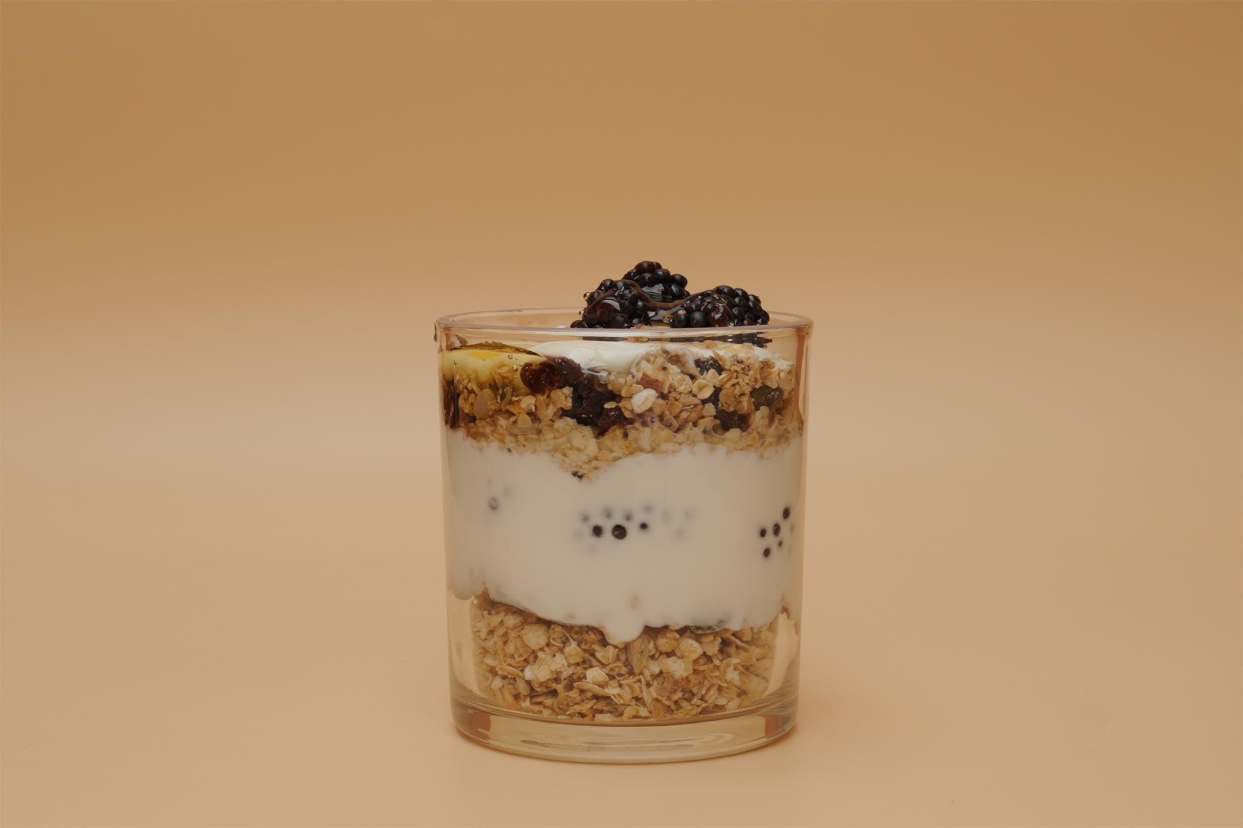 Artisan Granola parfait layered with creamy yoghurt, blackberries and natural oats in a glass — a wholesome, high-fibre, handmade breakfast rich in flavour and nutrition.